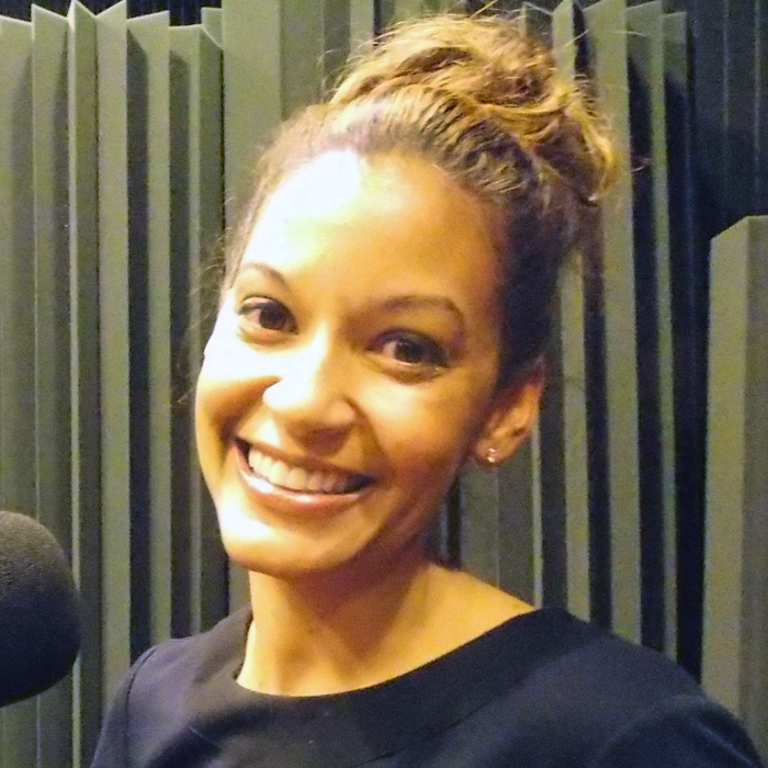 Audra Pittman sitting in WFSU's radio studio in front of the mic