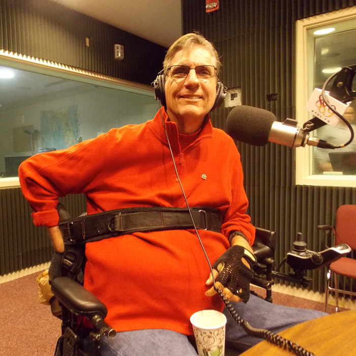 J. R. Harding sitting in WFSU's radio studio in front of the mic