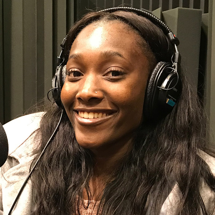 Kadasha Eliacin sitting in WFSU's radio studio in front of the mic