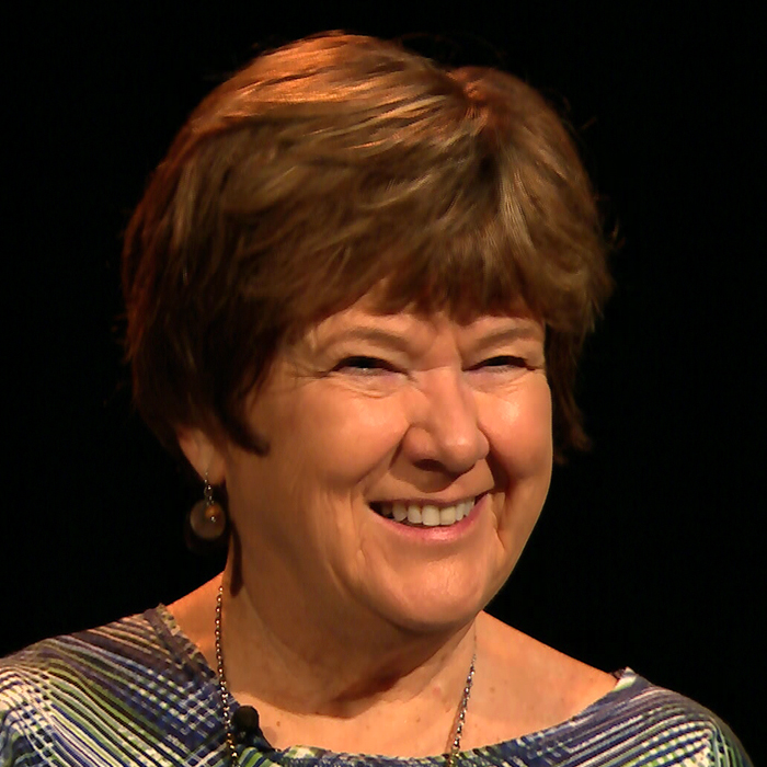 Mary McShane sitting in WFSU's radio studio in front of the mic