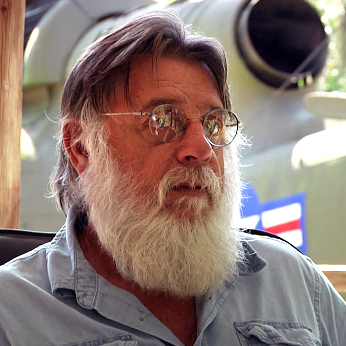 Rick Clevenger in front of an old warplane.