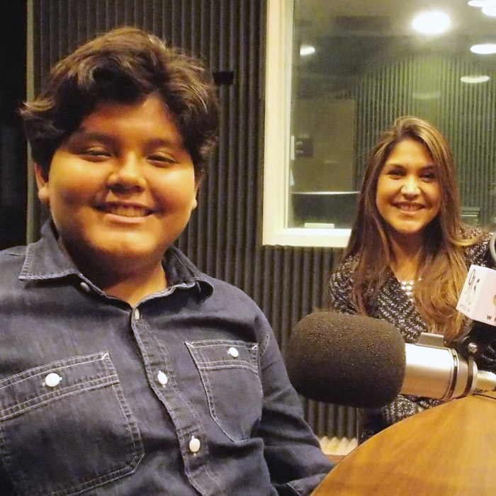 Veronica and Gabrielle Rios sitting in WFSU's radio studio in front of the mic