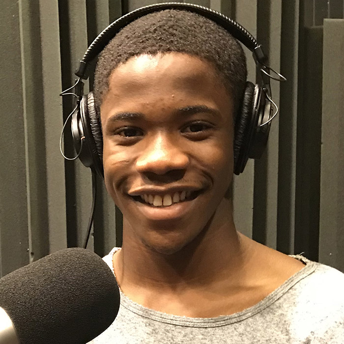 Ronnie Fields sitting in front of a microphone