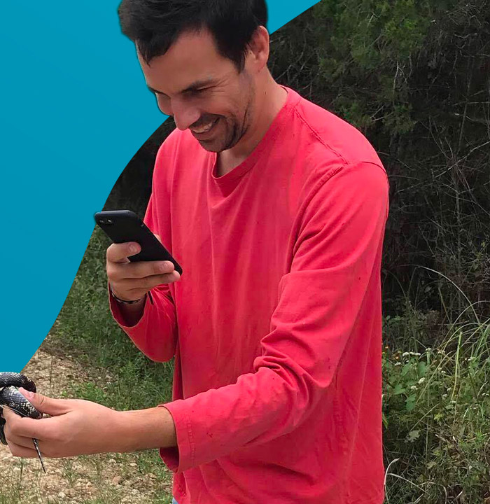 Man in teal shirt outdoors