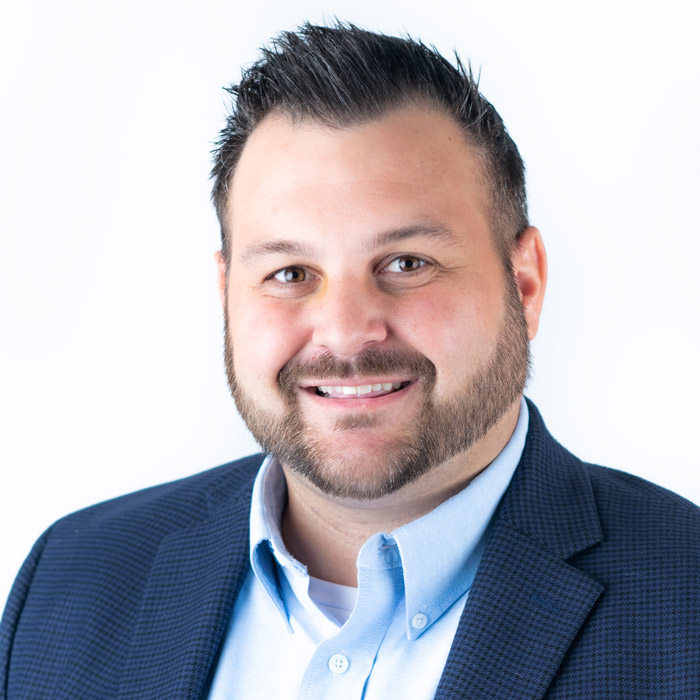 Bearded man smiling in blue suit