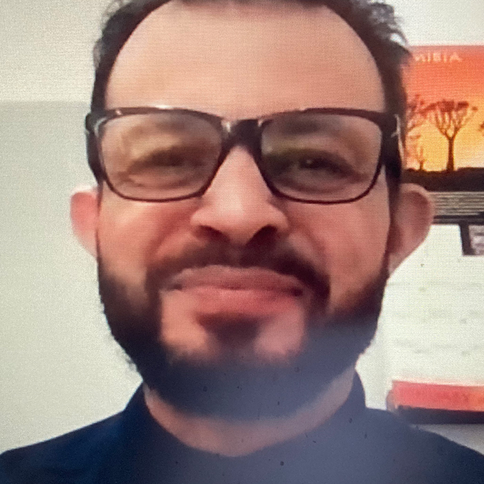 man with glasses smiling