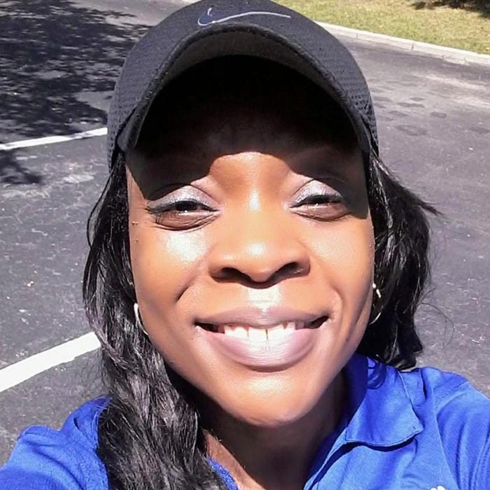 woman smiling with baseball cap